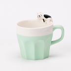 A cup full of warmth — and a cat on top!