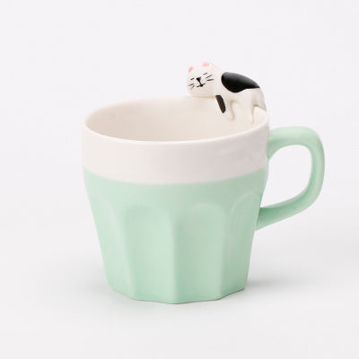 A cup full of warmth — and a cat on top!