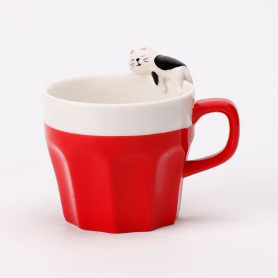 A cup full of warmth — and a cat on top!