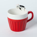 A cup full of warmth — and a cat on top!