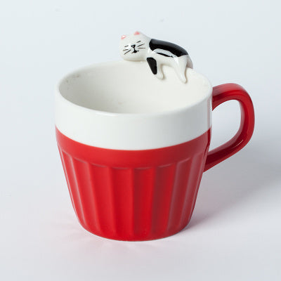 A cup full of warmth — and a cat on top!