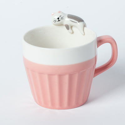 A cup full of warmth — and a cat on top!