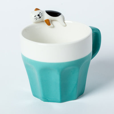 A cup full of warmth — and a cat on top!