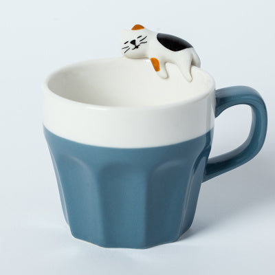 A cup full of warmth — and a cat on top!