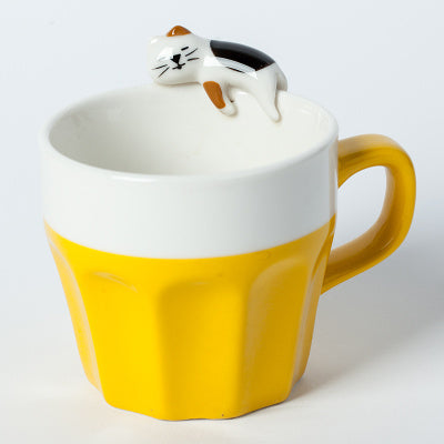 A cup full of warmth — and a cat on top!