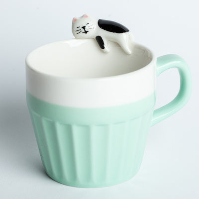 A cup full of warmth — and a cat on top!